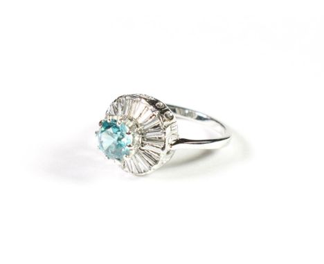 A blue zircon and diamond cluster ring, the round cut blue zircon within a border of baguette cut diamonds, in white claw and