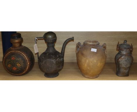 An Indo-Persian brass ewer, a parchment jar, painted metal flask and a tinned metal flask