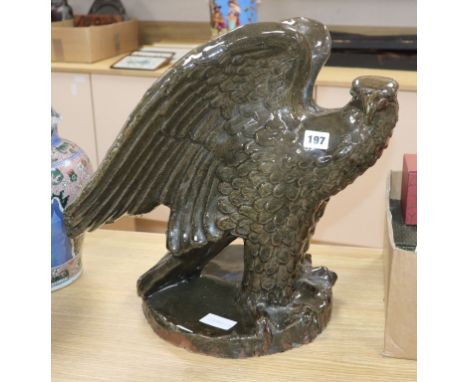 A large green glazed stoneware model of an eagle height 41cm