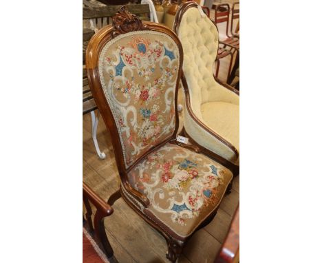 A Victorian walnut spoon back nursing chair with tapestry upholstery
