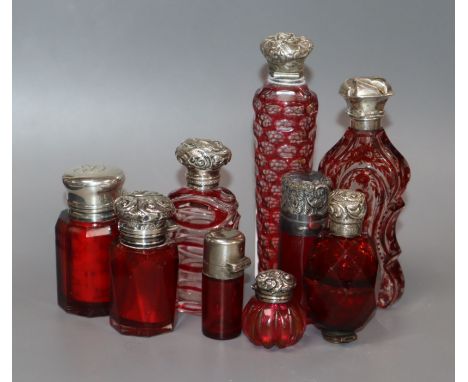 Nine assorted silver or white metal mounted glass scent bottles, including ruby glass, Bohemian &amp; Sampson Mordan &amp; Co