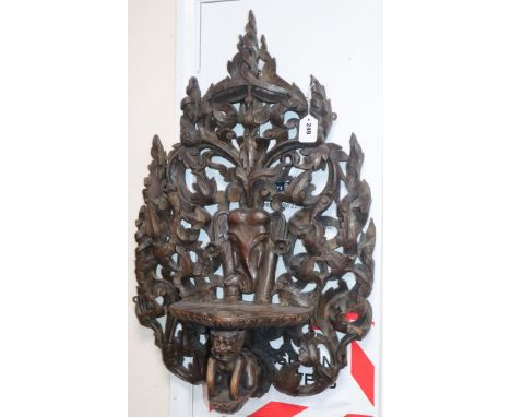 A Burmese or Indian teak wall bracket length 80cm