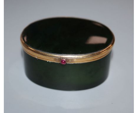 A Continental 18k yellow metal mounted, green nephrite jade oval pill box, with cabochon button, 50mm.