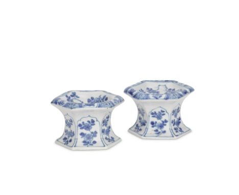 TWO BLUE AND WHITE HEXAGONAL SALTSKangxiEach with six cusped panels of floral sprays on the waisted hexagonal foot rising to 