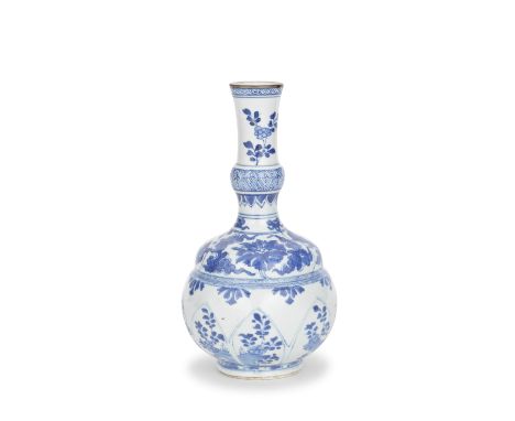 A BLUE AND WHITE PETAL-MOULDED VASEEarly KangxiThe lower body with petal moulded lappets decorated with flowering plants, bel