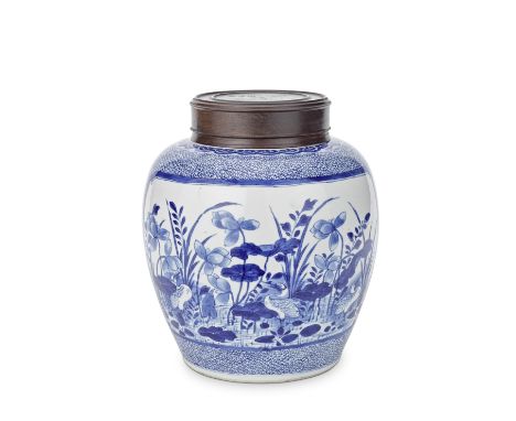 A BLUE AND WHITE 'LOTUS POND' JARKangxiDecorated with a panel of herons wading in a lotus pond, the reverse with antiques and