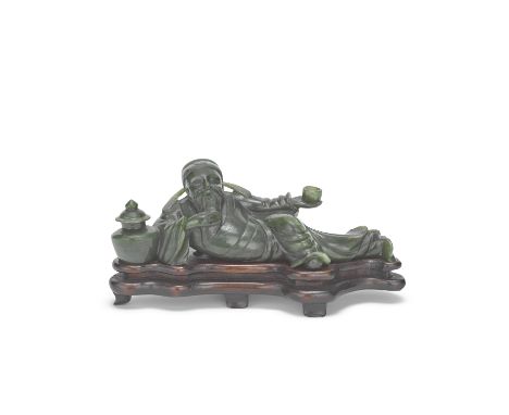 A SPINACH JADE 'LI BAI' CARVINGQing DynastyThe poet modelled recumbent, one arm, outstretched holding a wine cup and the othe