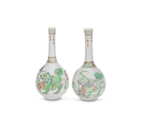 A NEAR PAIR OF FAMILLE VERTE 'BUDDHIST LION' BOTTLE VASESKangxiEach brightly decorated around the body with three animated Bu