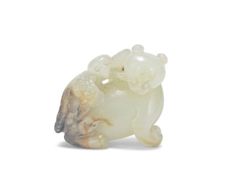 A CELADON AND RUSSET JADE 'BEAR AND EAGLE' GROUP CARVING17th/18th centuryThe bear modelled seated with its head turned to the