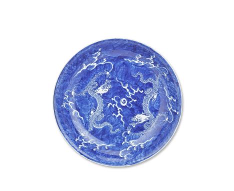 A BLUE AND WHITE 'DOUBLE DRAGON' DISHKangxiDecorated to the centre with an ascending and descending dragon in pursuit of the 