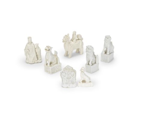 A GROUP OF BLANC-DE-CHINE WARES17th/18th centuryComprising: a pair of Buddhist lion joss stick holders; a group of a scholar 