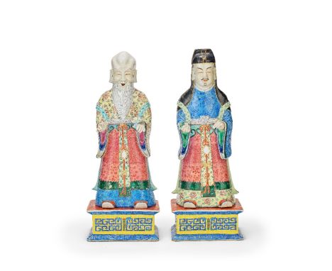 A LARGE PAIR OF FAMILLE ROSE IMMORTALS AND STANDS19th centuryEach standing and dressed in elaborately decorated robes, with a