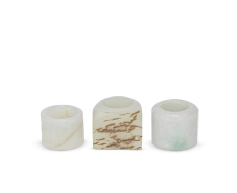 THREE JADE ARCHER'S RINGSQing DynastyComprising: a white jade ring carved with a sage in a mountainous landscape; a pale cela