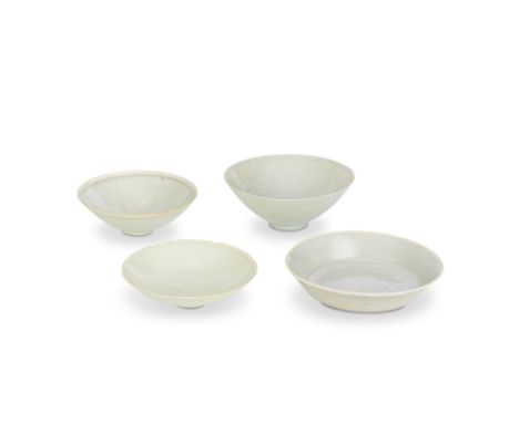 FOUR QINGBAI BOWLSSong/Yuan DynastyComprising: a foliate rimmed bowl carved with a peony medallion to the well; a deep bowl d