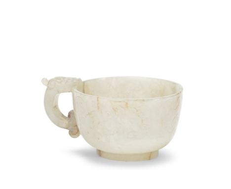 A PALE CELADON JADE 'CHILONG' HANDLED CUP16th/17th century   Of oval form set on a short foot, carved around the body with ar