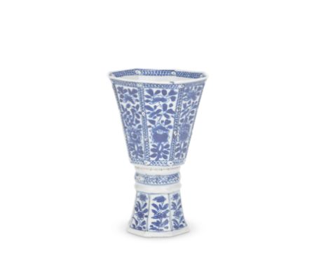 A BLUE AND WHITE OCTAGONAL STEM CUPKangxi Each side painted with a panel containing a single stem of blossoms and leaves, the