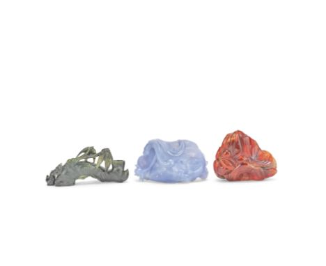 THREE CARVED HARDSTONE SCHOLAR'S DESK ITEMS19th/20th centuryComprising: a spinach jade bamboo root brush rest, wood stand; a 