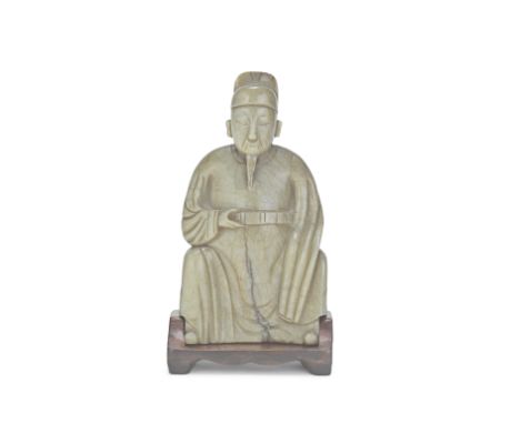A MOTTLED PALE GREY-CELADON JADE CARVING OF A SCHOLAR17th centuryThe figure seated wearing a scholar's cap and flowing robes,