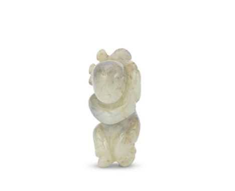 A MOTTLED JADE CARVING OF A BOYMing DynastyThe smiling figure modelled with the right leg slightly raised and holding a lotus