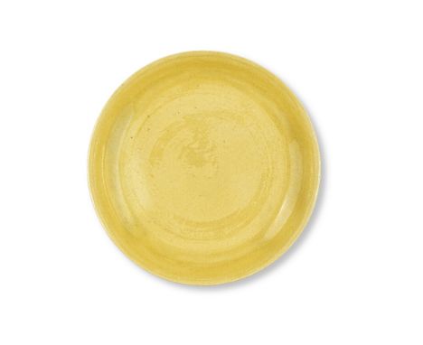 A YELLOW-GLAZED DISHKangxiThe wide shallow rounded sides rising from a short foot to a gently flared rim, covered overall in 