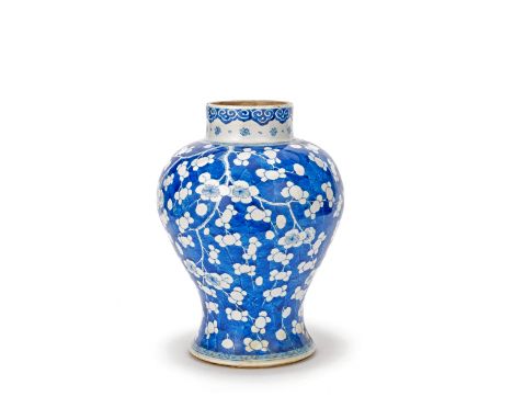 A BLUE AND WHITE 'PRUNUS' JARKangxiOf baluster form, painted overall with blossoming sprays of prunus reserved on a blue 'cra