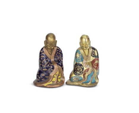 TWO CHAMPLEVÉ ENAMEL FIGURES OF LUOHAN18th/19th centuryEach seated with the bald head lowered enclosed in long flowing robes,