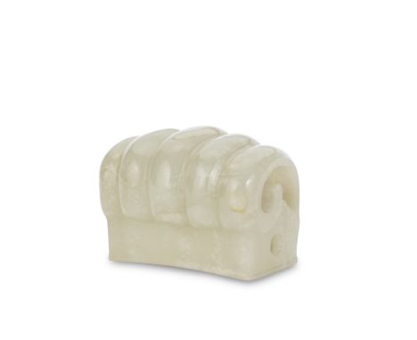 A CELADON JADE HAIR ORNAMENTMing DynastyCarved to the upper surface with five coiled ribs, resting on a hollow, gently curved