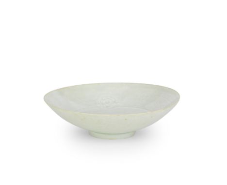 A QINGBAI 'PEONY' BOWLSong DynastyThe shallow rounded sides rising from a short foot, carved to the interior with a central p