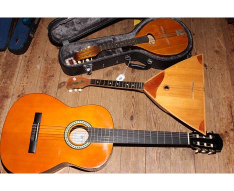 Acoustic guitar by Messina with bag, Balalaika and Ozark mandolin cased.