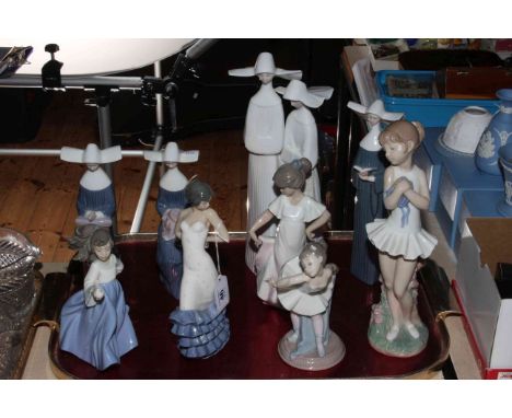 Four Lladro Nun figures and five Nao figures including two ballerinas.