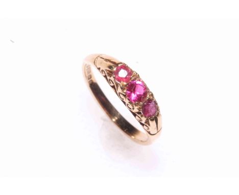 9 carat gold and three stone ruby ring, hallmarked for Birmingham 1979, size I/J.