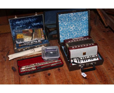 Cased flute, cased clarinet, cased trumpet, Russian piano accordion, Irish whistle, two recorders and eight mouth organs.