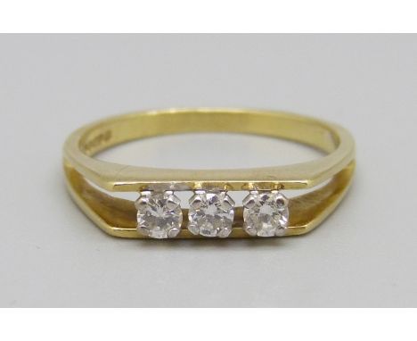 An 18ct gold, three stone diamond ring, 2.7g, M 