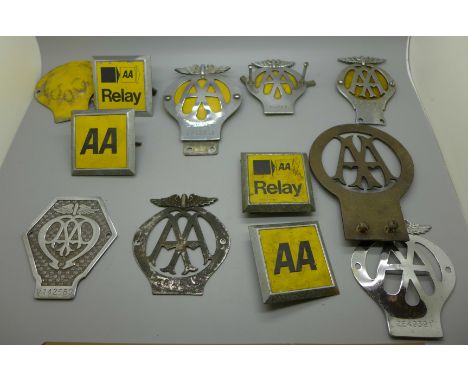 A collection of vintage AA car badges, including pre-war, one numbered 36154L 