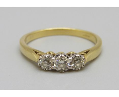 An 18ct gold, three stone diamond ring, 2.9g, O 