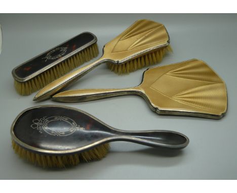 A silver and enamel mirror, a similar brush and two silver and tortoiseshell brushes 