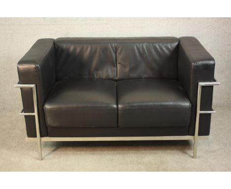 After Le Corbusier, an LC2 two seater sofa, with black leather upholstery and a chromed tubular frame. H.75 W.140 D.76cm. 