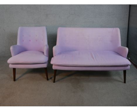 A contemporary mid 20th century Designers Guild sofa and armchair, upholstered in purple fabric with purple backs, on taperin