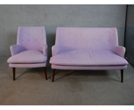 A contemporary mid 20th century Designers Guild sofa and armchair, upholstered in purple fabric with purple backs, on taperin