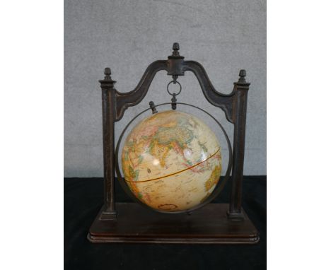 A Thomas Blakemore reproduction terrestrial globe, hanging from a cast iron frame on a mahogany plinth. H.43 W.37 D.19cm 