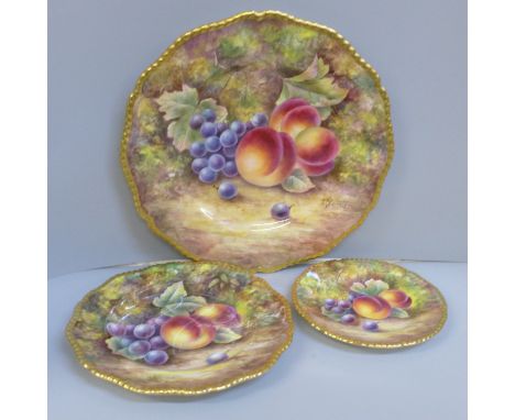 A set of three graduated Royal Worcester hand painted cabinet plates, decorated with fruit, signed J. Skerrett