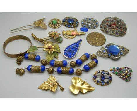 A collection of assorted brooches, a necklace and a bangle, etc. 