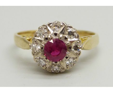An 18ct yellow gold cluster ring set with eight round brilliant cut diamonds (2mm) and a central ruby (4mm), 2.7g, I 