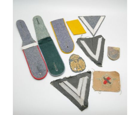 A selection of German uniform cloth badges and epaulettes 