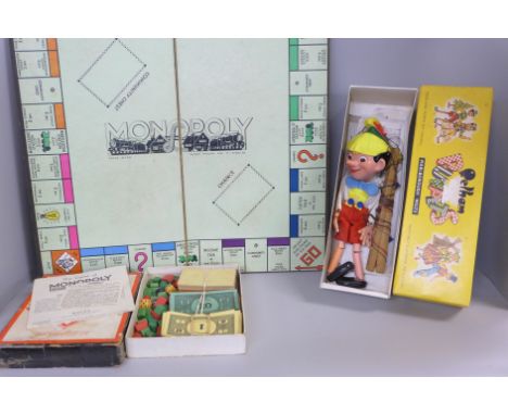 A Pinocchio Pelham puppet and a vintage Monopoly game 