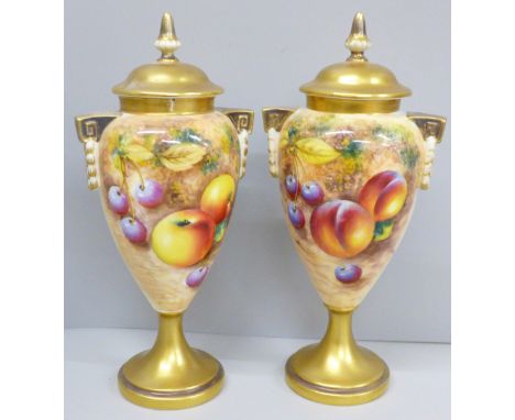 A pair of Royal Worcester hand painted vases and covers, decorated with fruit, signed, one vase and cover a/f 