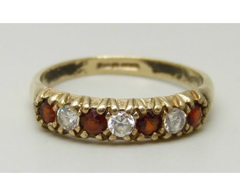 A 9ct gold, garnet and white stone ring, 1.4g, K 