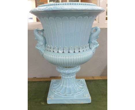 A large pale blue glazed ceramic garden urn with fish handles, 55cm