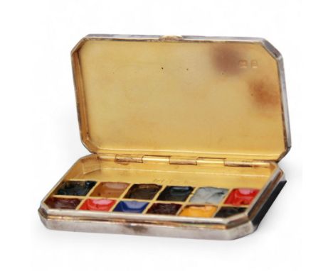 Modern silver miniature paint box, of plain rectangular form with canted corners, the hinged cover lifting to reveal a compar