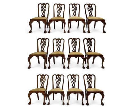 Set of twelve Chippendale design mahogany dining chairs, shaped cresting rail carved with foliage and C-scrolls, pierced inte